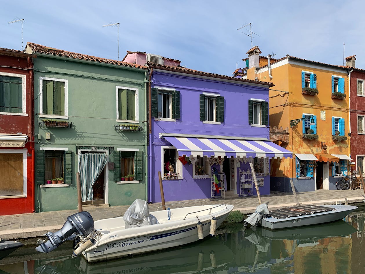 Burano canal scene with colorful houses and moored boats
