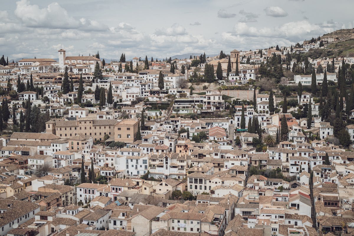 Panoramic view of Granada rooftops and traditional architecture with Sierra Nevada mountains in the distance
