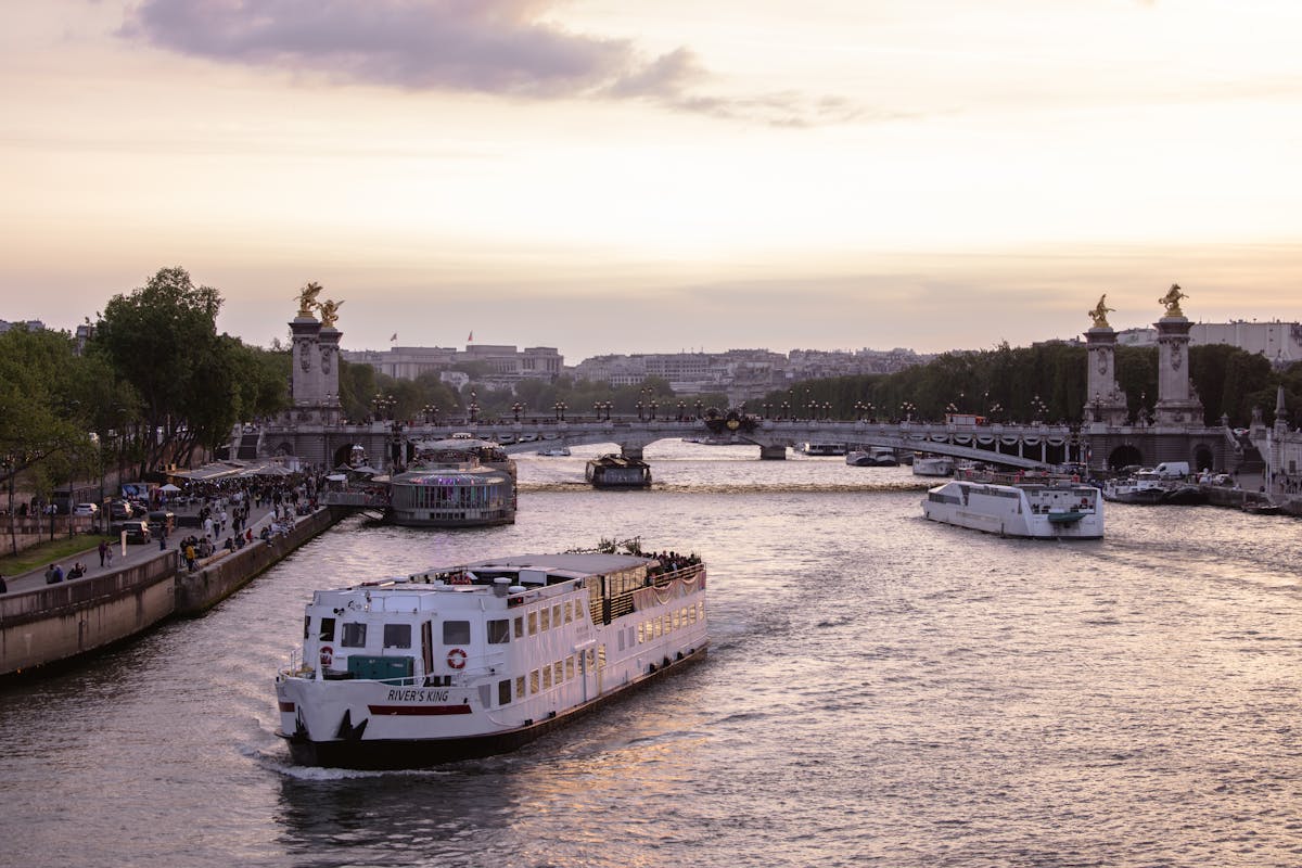Golden hour light over the Seine River with the Pont Alexandre III bridge in the foreground