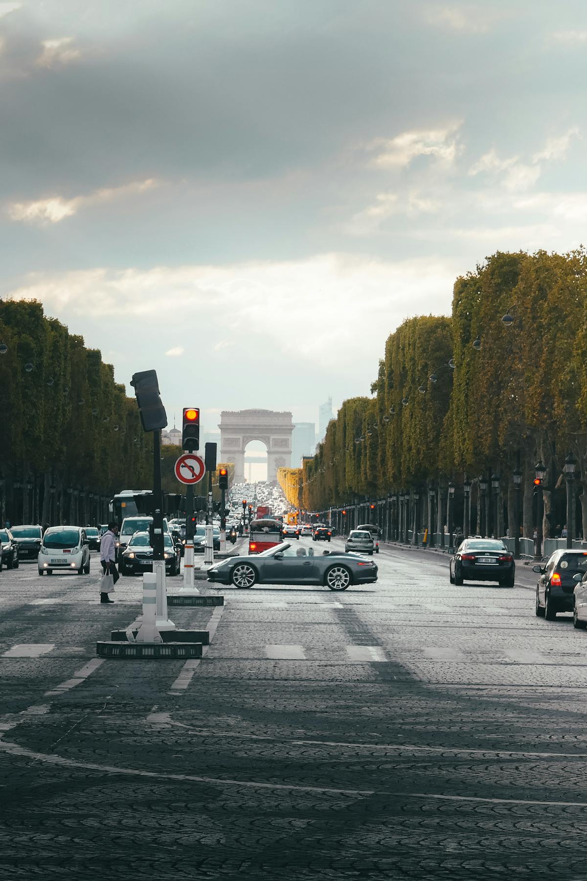 Looking down the Champs-Elysees toward the Arc de Triomphe, framed by trees