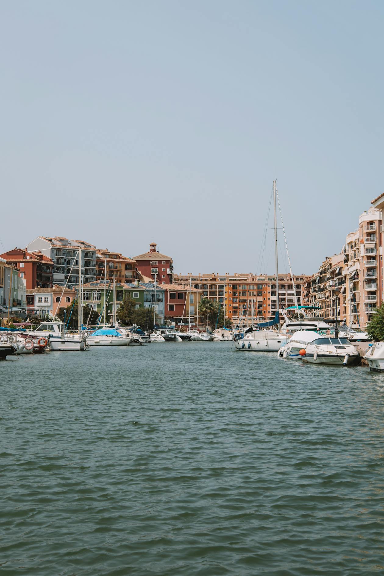 Colourful waterfront buildings and moored boats at Port Saplaya near Valencia