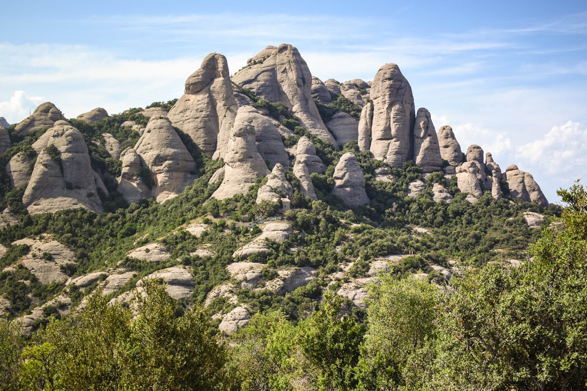 Close up of Montserrat distinctive rounded rock pillars with hiking paths winding through