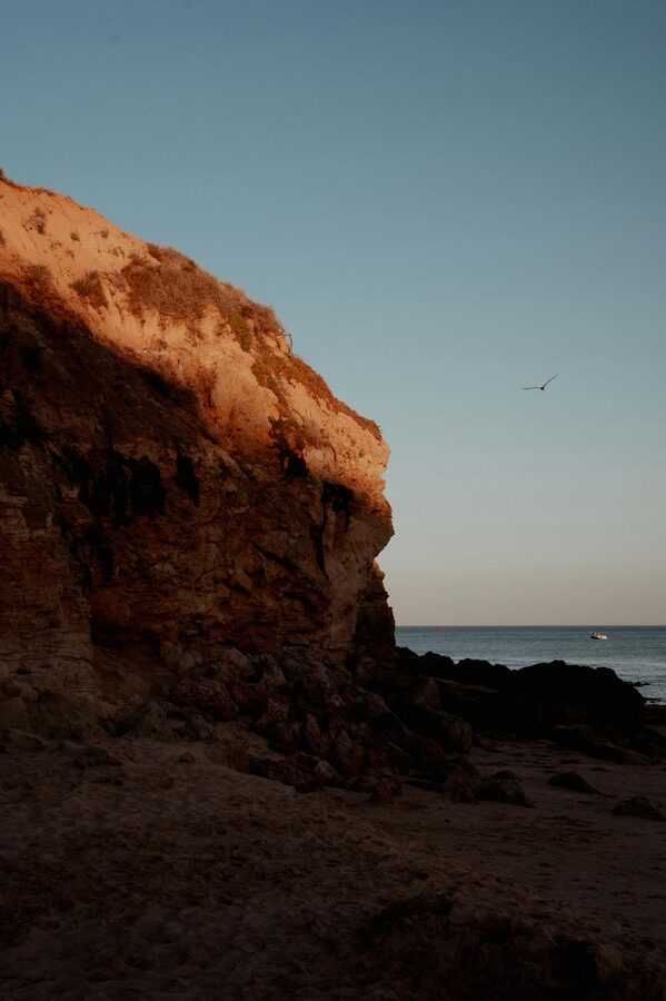 Sunlit golden cliffs along the Albufeira coastline at sunset
