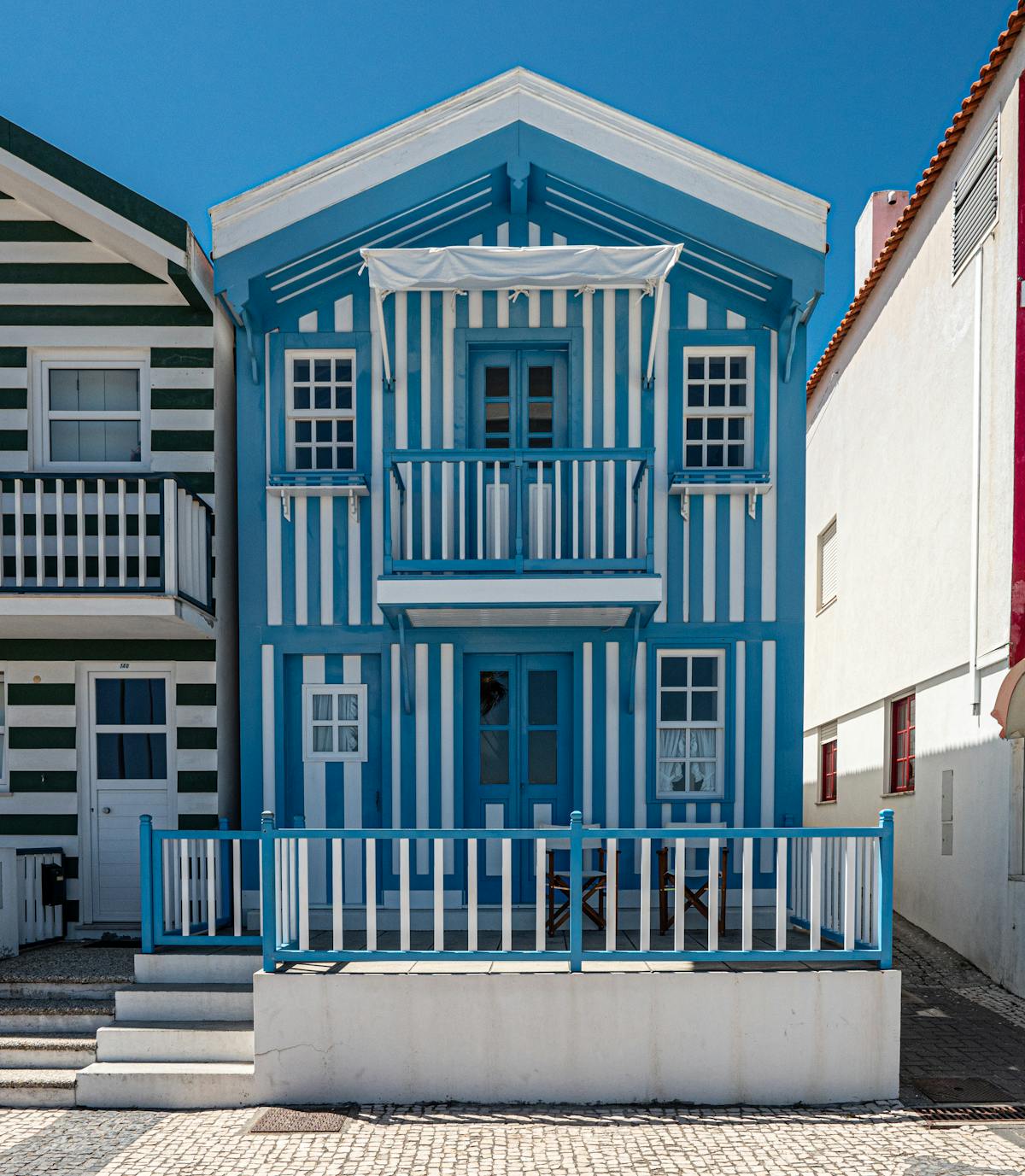 Colorful striped houses in Costa Nova showcasing coastal Portuguese architecture
