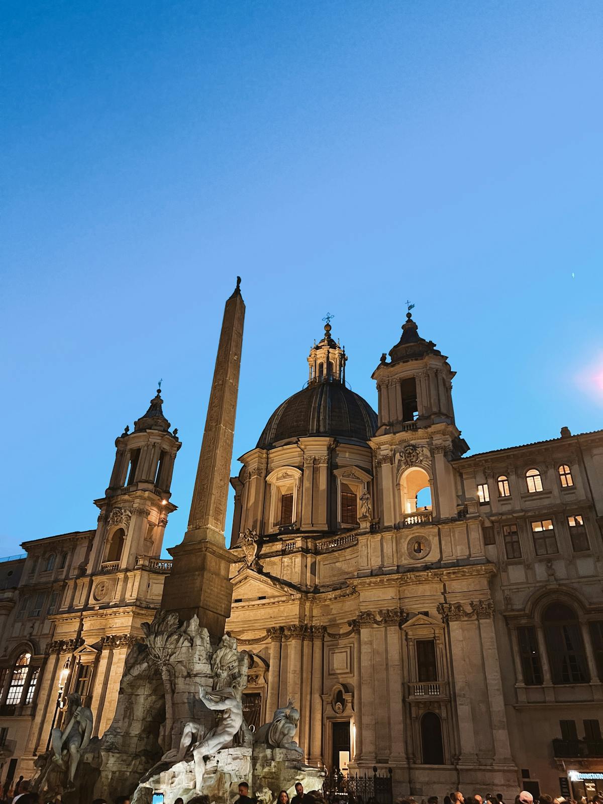 Fontana dei Quattro Fiumi and SantAgnese church in Rome during twilight