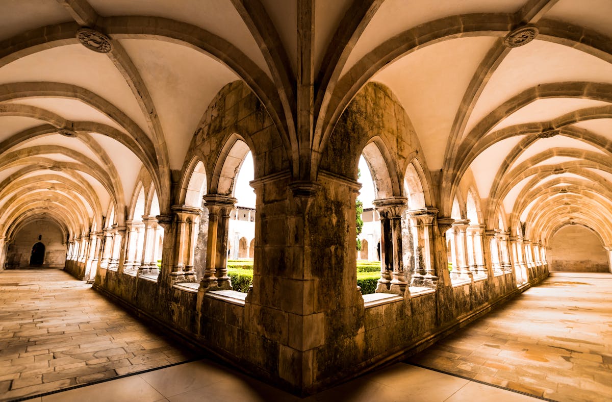 Gothic cloisters with intricate vaulted ceilings at Batalha Monastery in Portugal