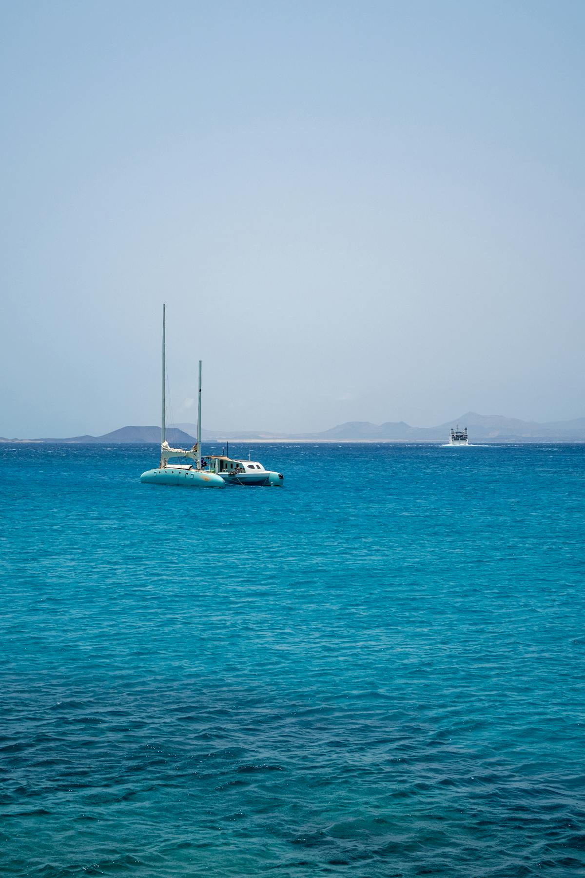 Catamaran anchored on turquoise sea near the Canary Islands