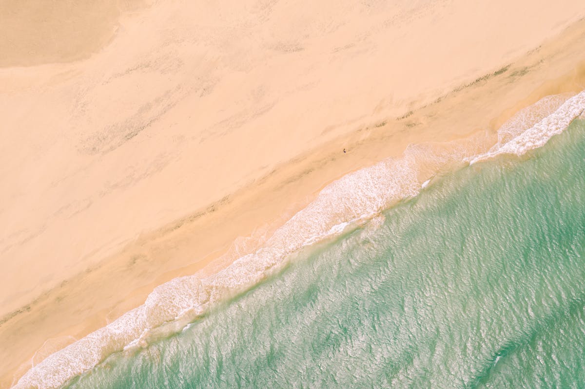 Aerial view of sandy beach and turquoise ocean at El Cotillo Fuerteventura