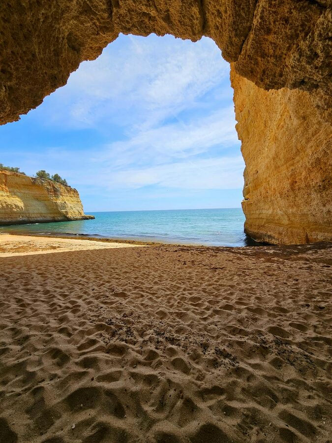 A coastal cave in the Algarve opens up to reveal a stunning view of the sea and cliffs