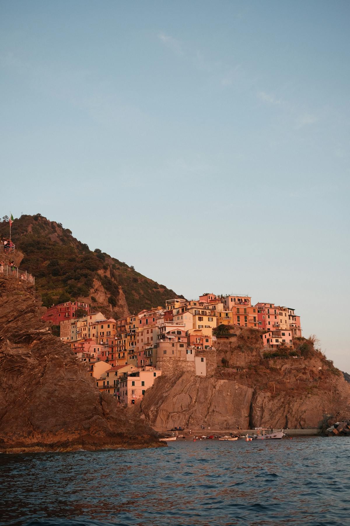 Coastal village of Manarola at sunset with colorful buildings on cliff