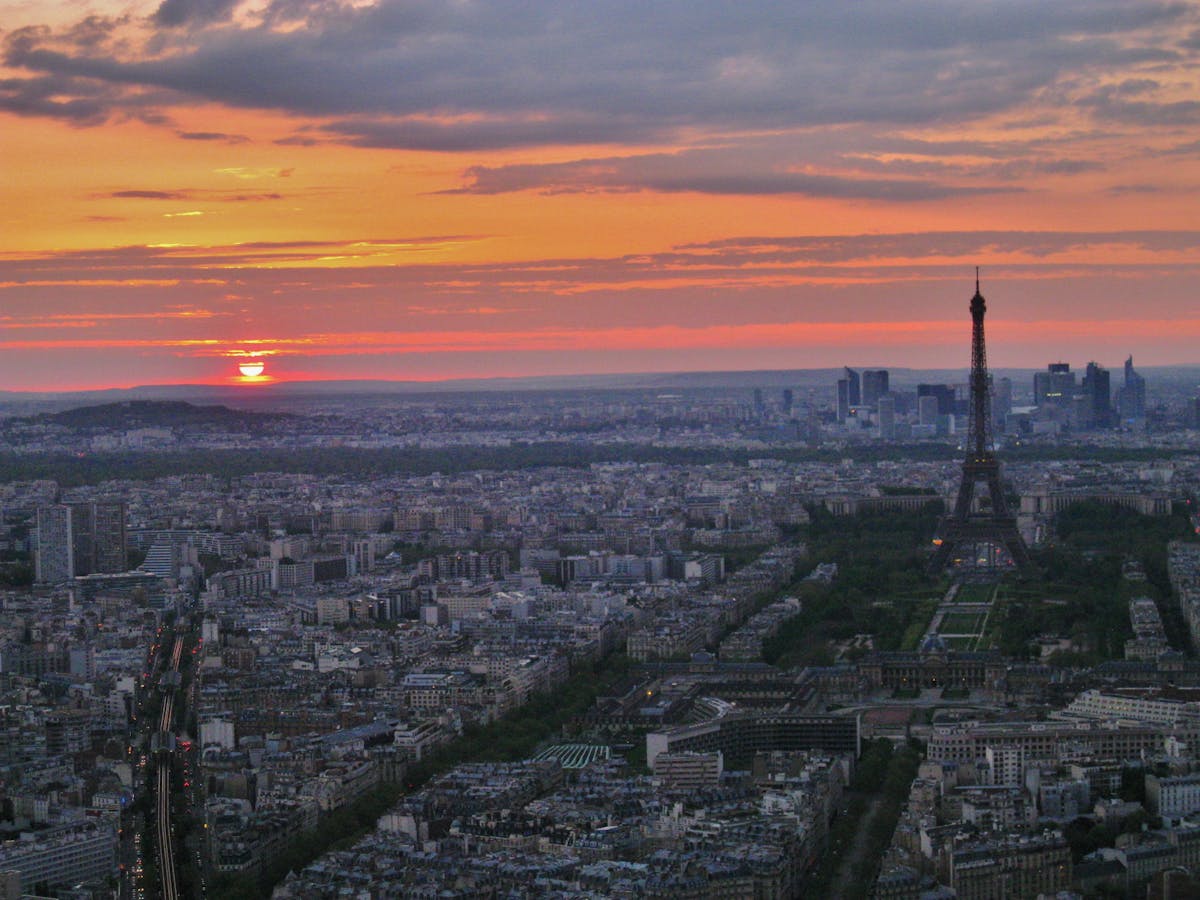 Aerial view of Paris at sunset with the Eiffel Tower glowing gold