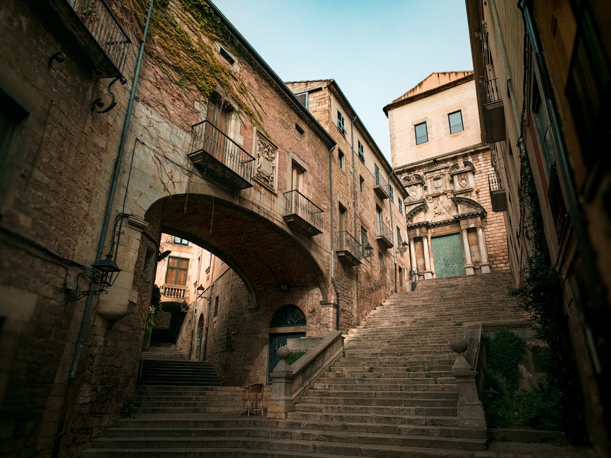 Stone stairway in the Girona historic district with arched passageway