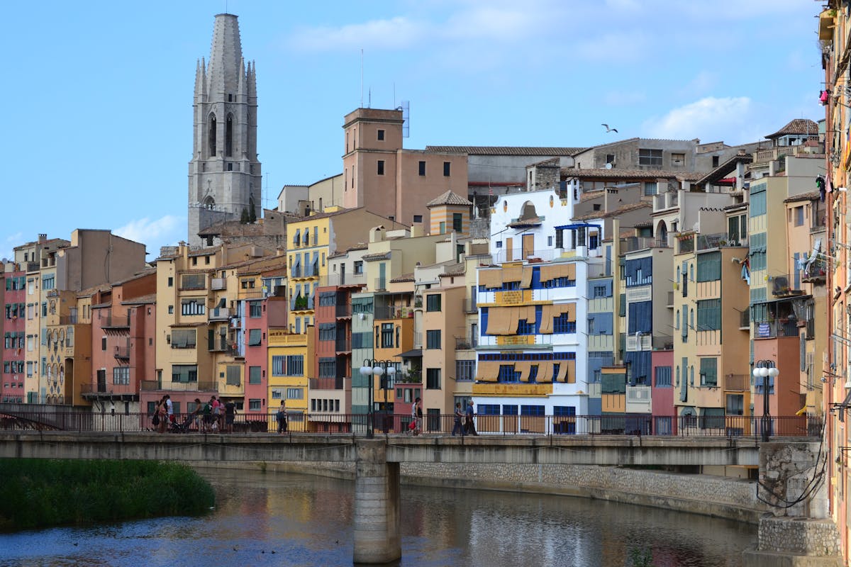 View of Girona with the cathedral rising above the colourful riverside buildings
