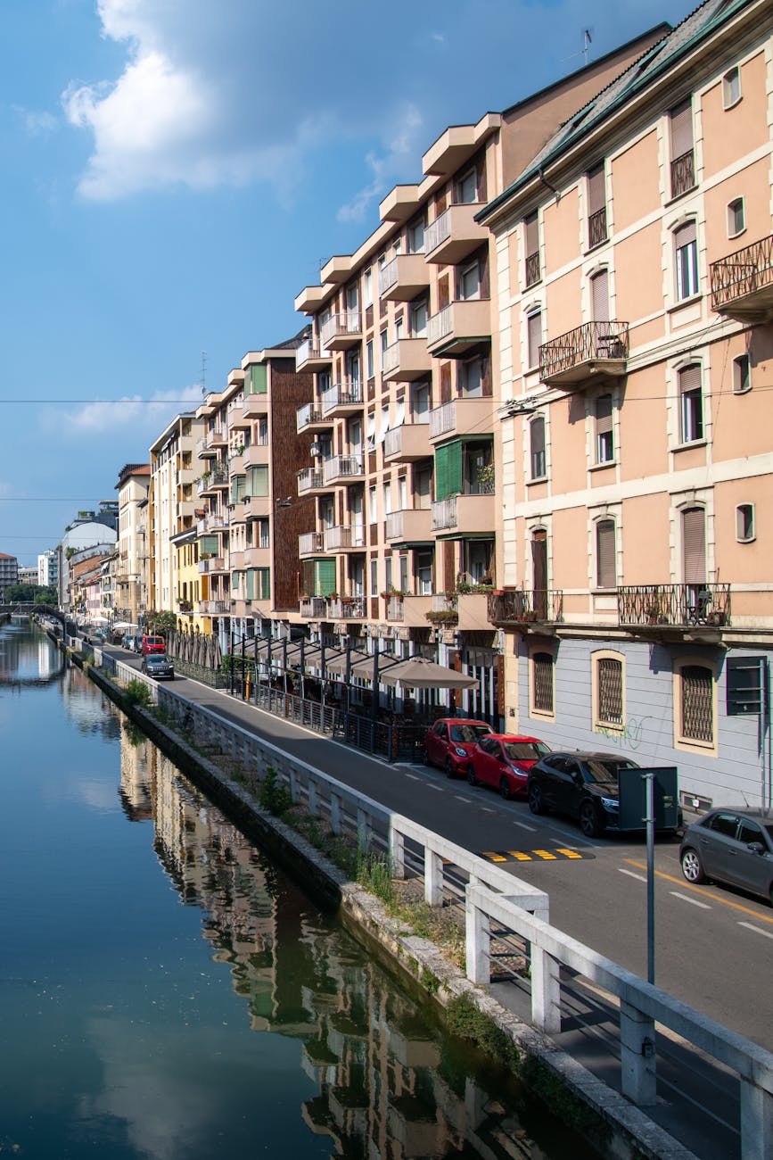 Colorful buildings reflecting in the waters of Naviglio Grande canal in Milan