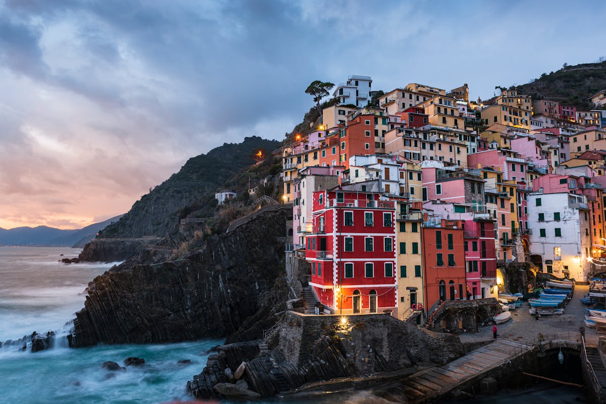 Riomaggiore colorful houses on cliffside at sunset Cinque Terre