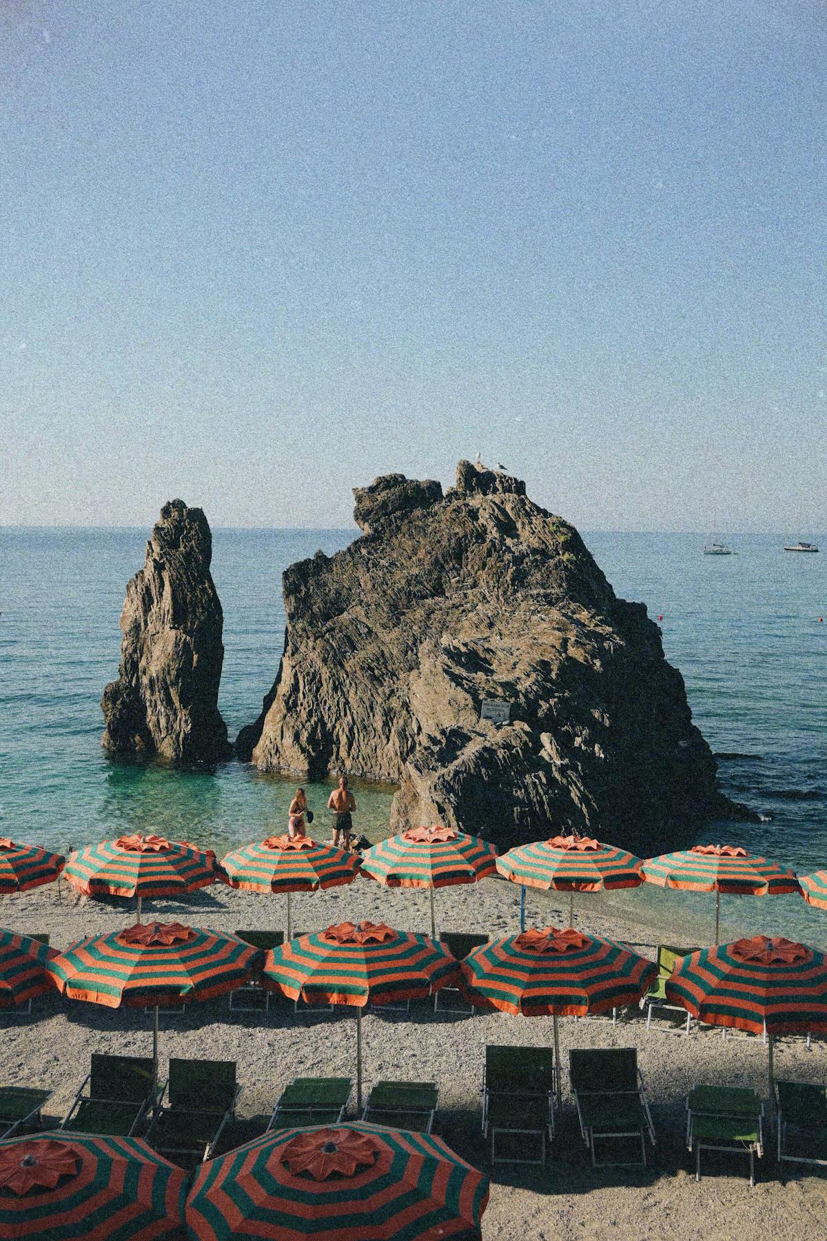 Beach with striped umbrellas in Monterosso al Mare Cinque Terre