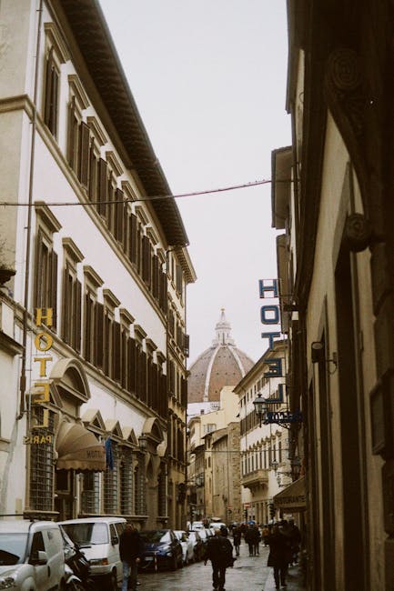 Narrow Florence alleyway with the Duomo dome visible between buildings