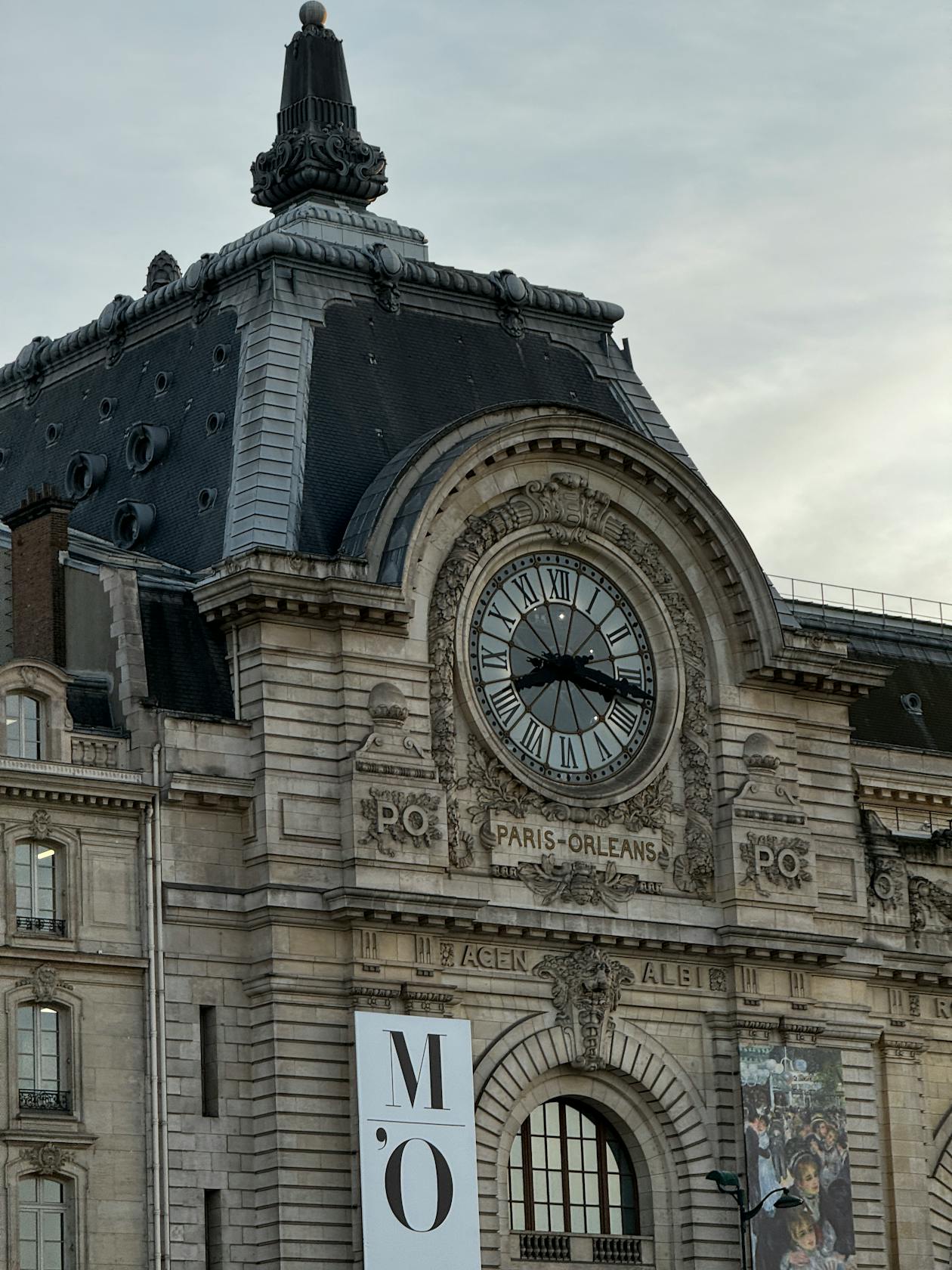 The Musee dOrsay clock tower illuminated at dusk in Paris