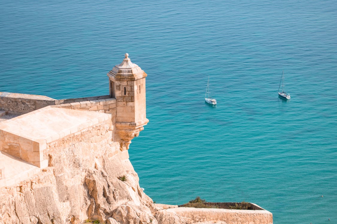 Fortress overlooking the Mediterranean Sea and anchored sailboats in Alicante