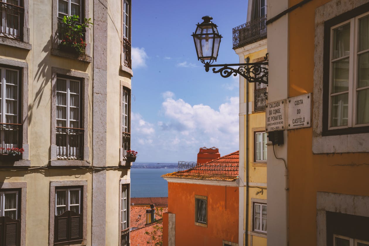 View from Alfama district showing historic architecture and ocean horizon in Lisbon