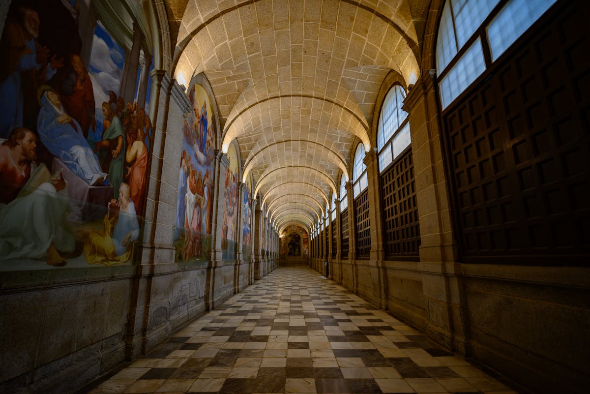 Gorgeous corridor with arched stone ceilings and mural paintings in a historic Madrid building