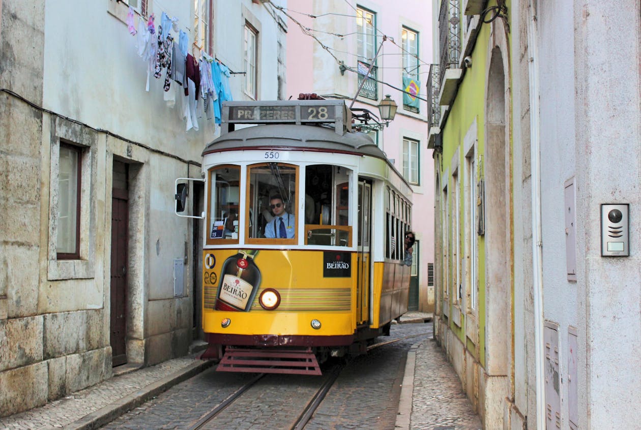 Yellow tram 28 in narrow Lisbon street