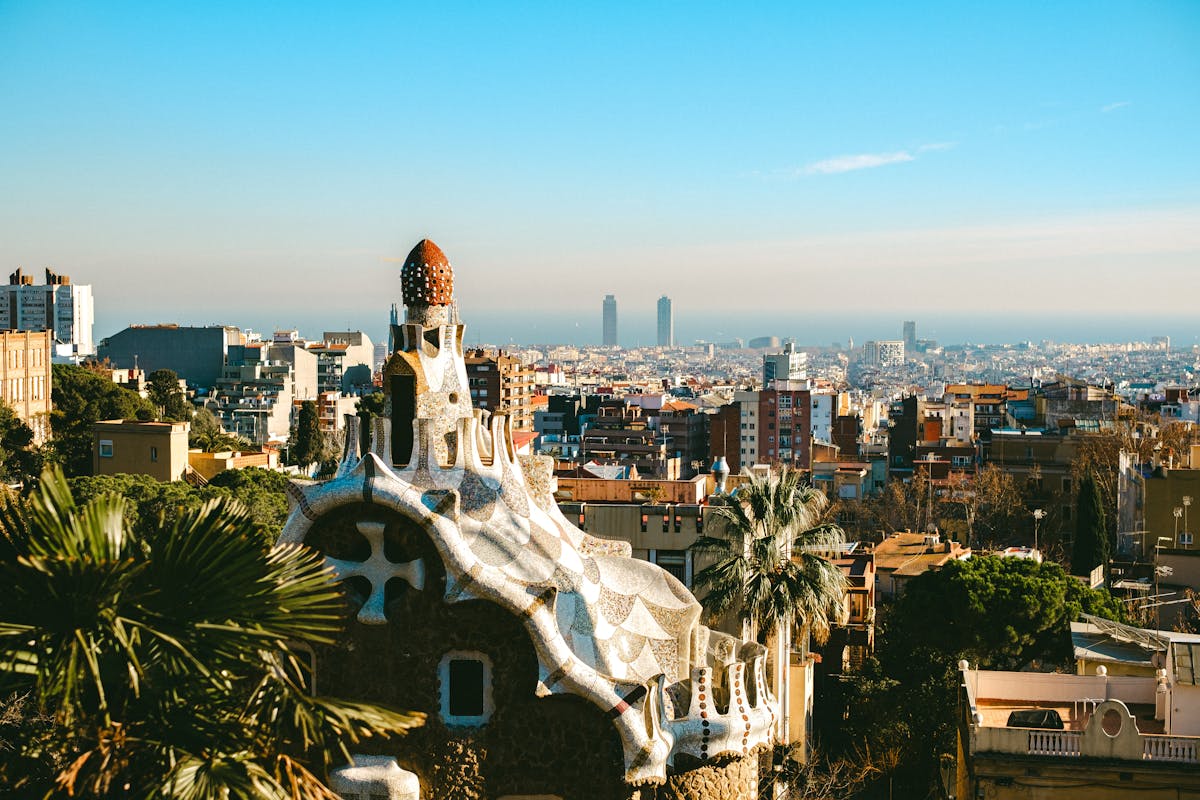 Aerial view of Park Guell unique architecture with Barcelona cityscape in the background