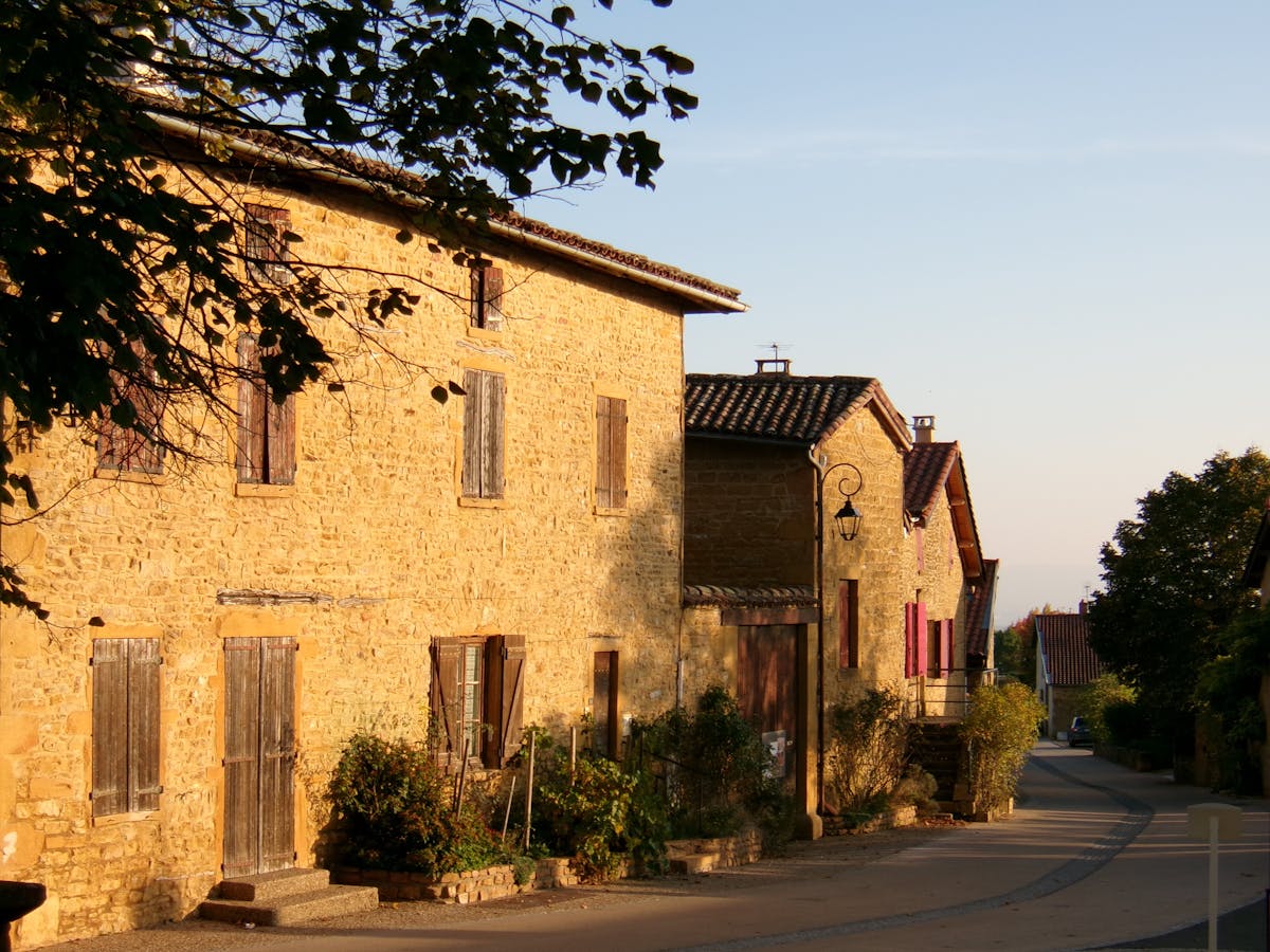 Traditional stone buildings and flower-lined streets in a picturesque French village