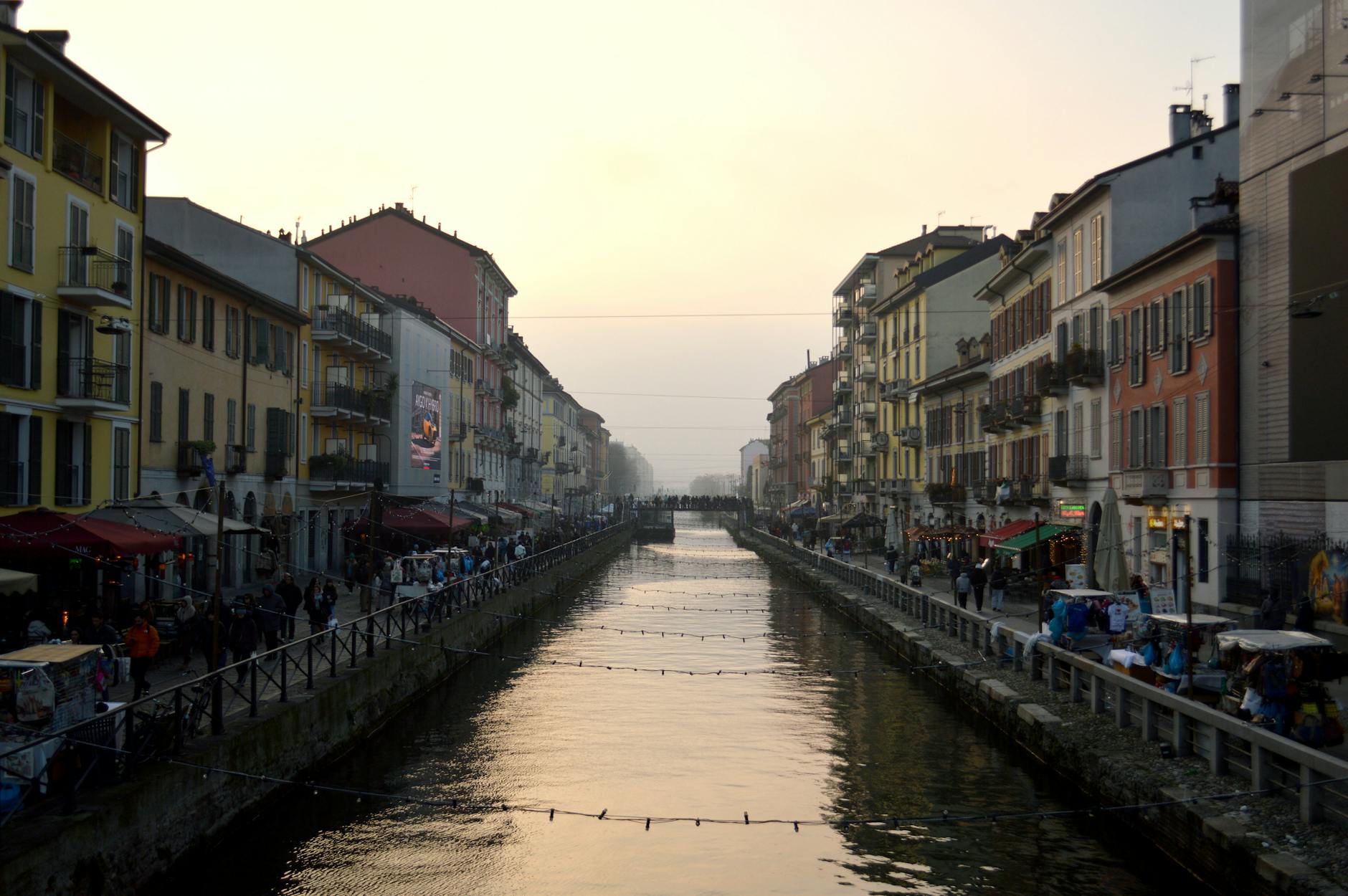 Sunset view of Naviglio Grande canal in Milan with colorful buildings on both sides