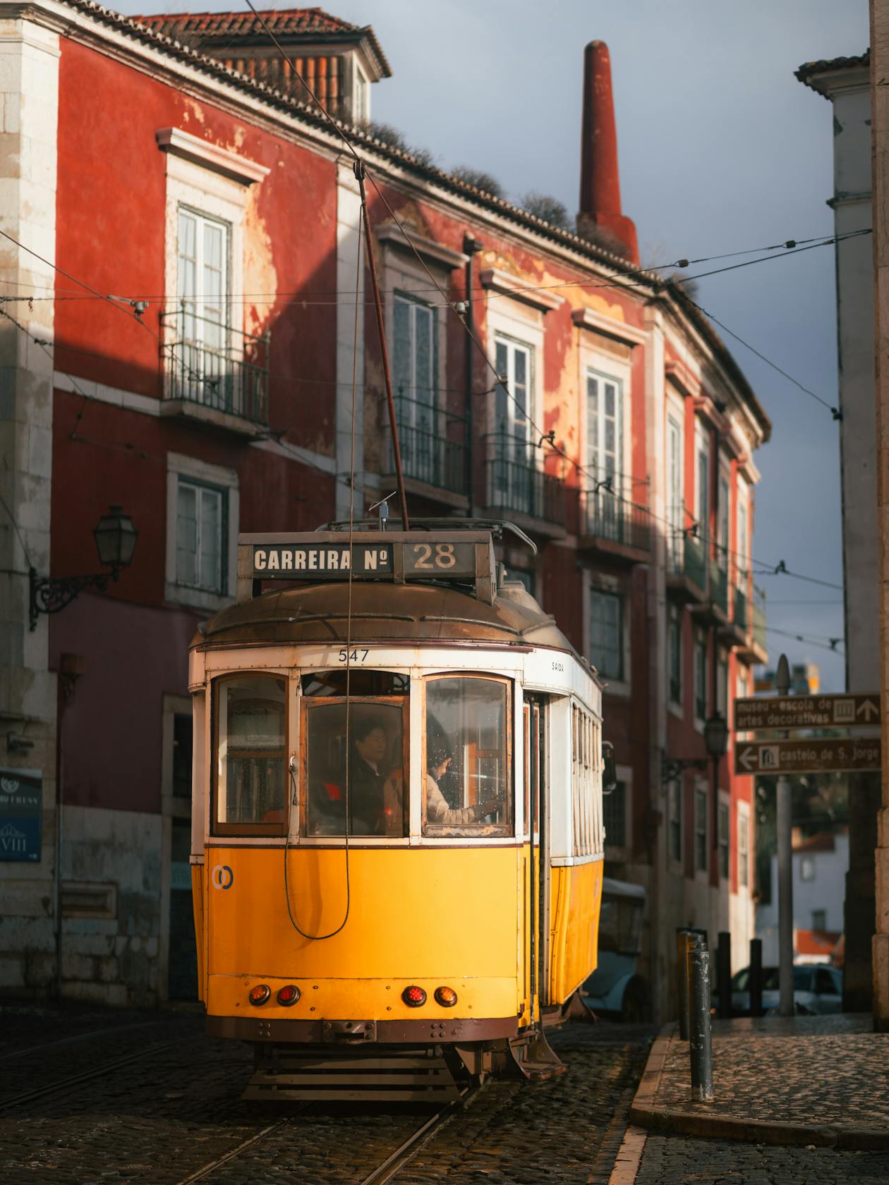 Historic Tram 28 navigating through charming streets of Lisbon
