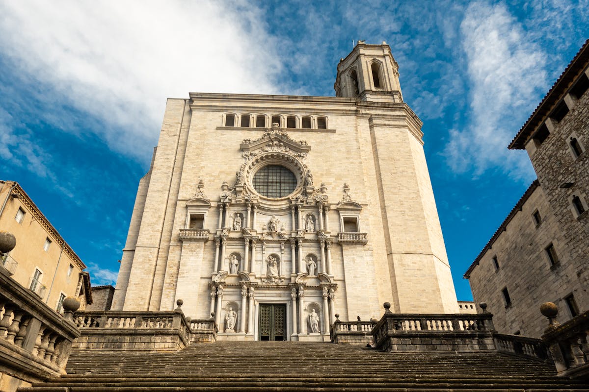 The imposing facade of Girona Cathedral against a clear sky