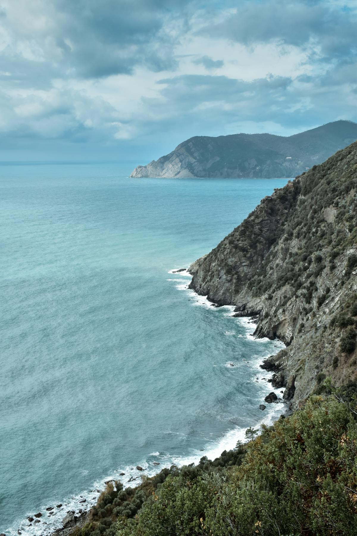 Dramatic cliffs and azure waters along the Ligurian coastline Italy