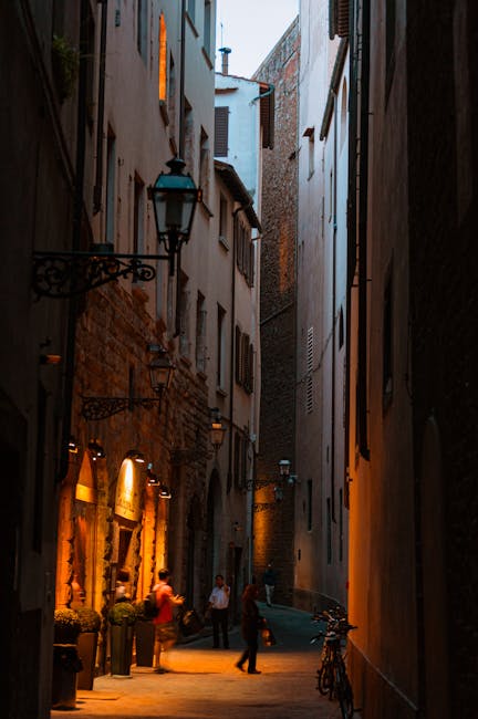Narrow Florence street at twilight with classic Tuscan architecture on both sides