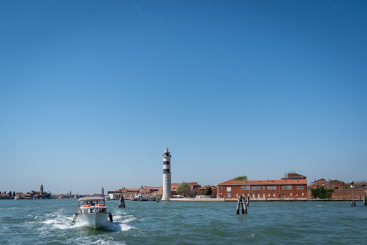 Speedboat near Murano iconic lighthouse in Venice lagoon Italy