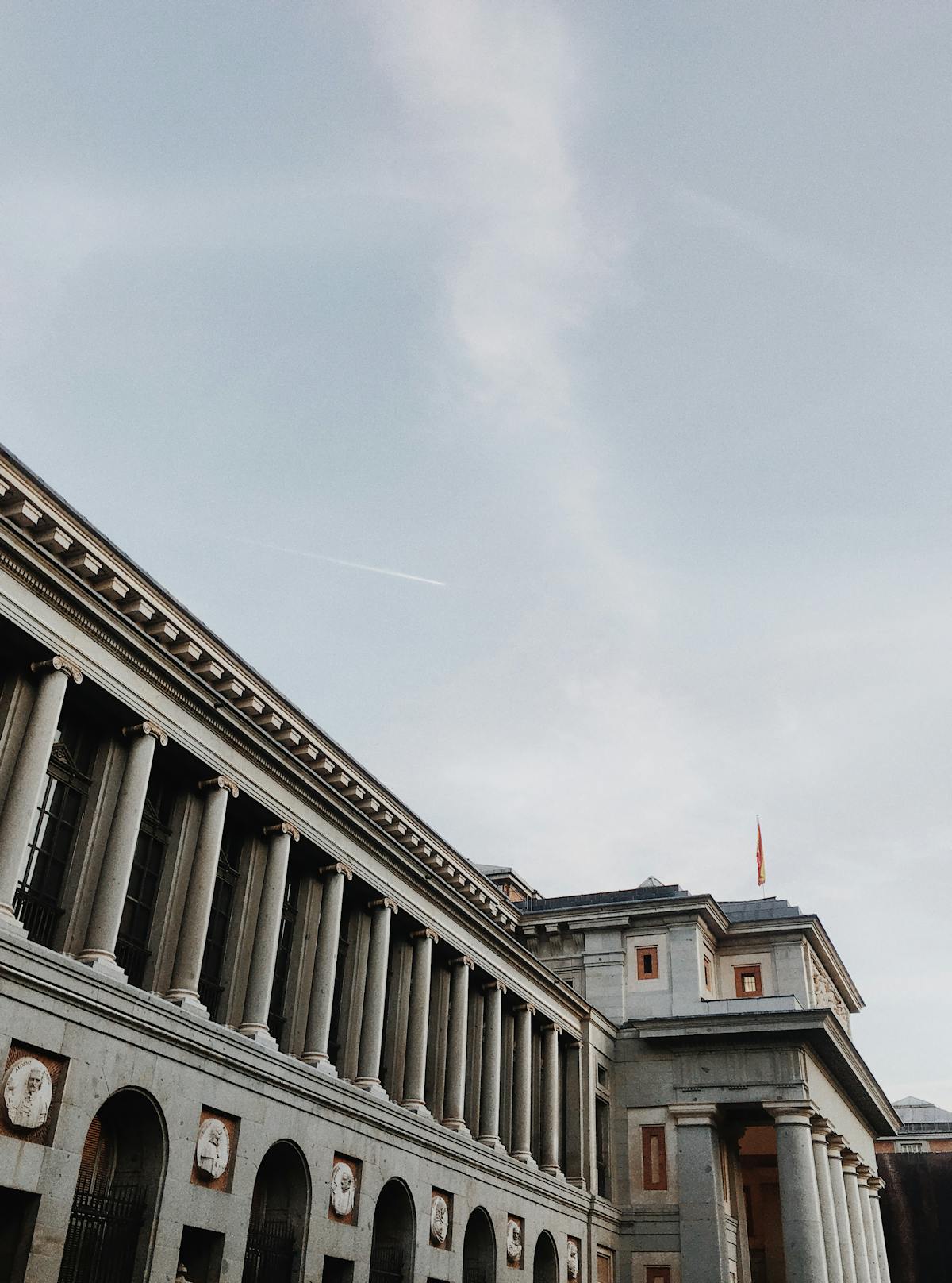 The Prado Museum building in Madrid against a clear blue sky with classic neoclassical architecture