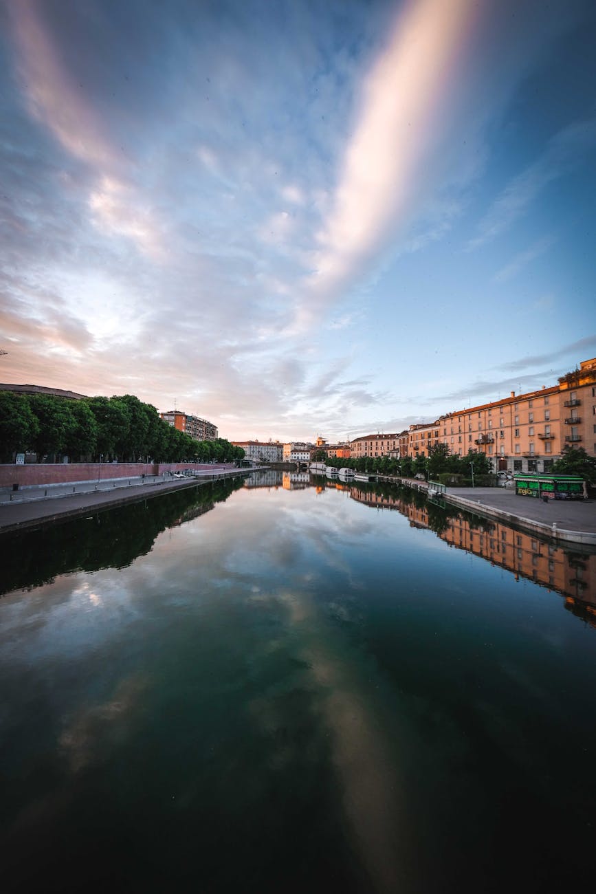 A calm canal flowing through apartment buildings in the Navigli area of Milan