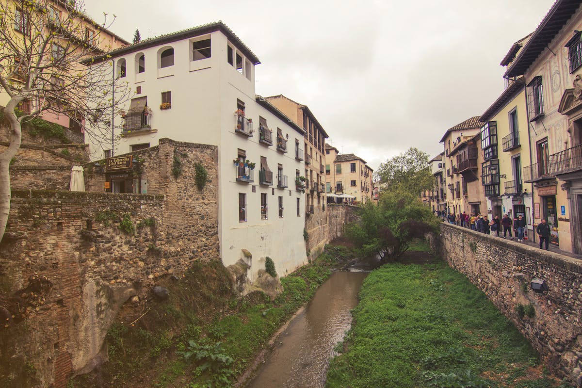 Historic Granada street view with traditional buildings along the Darro River