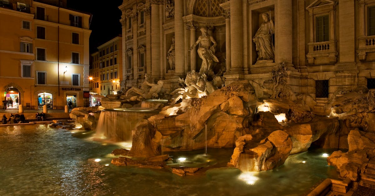 The Trevi Fountain in Rome glowing at night