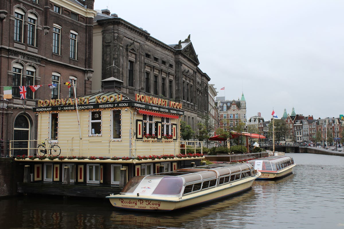 Low-angle view of Amsterdam canal from water level with buildings rising above