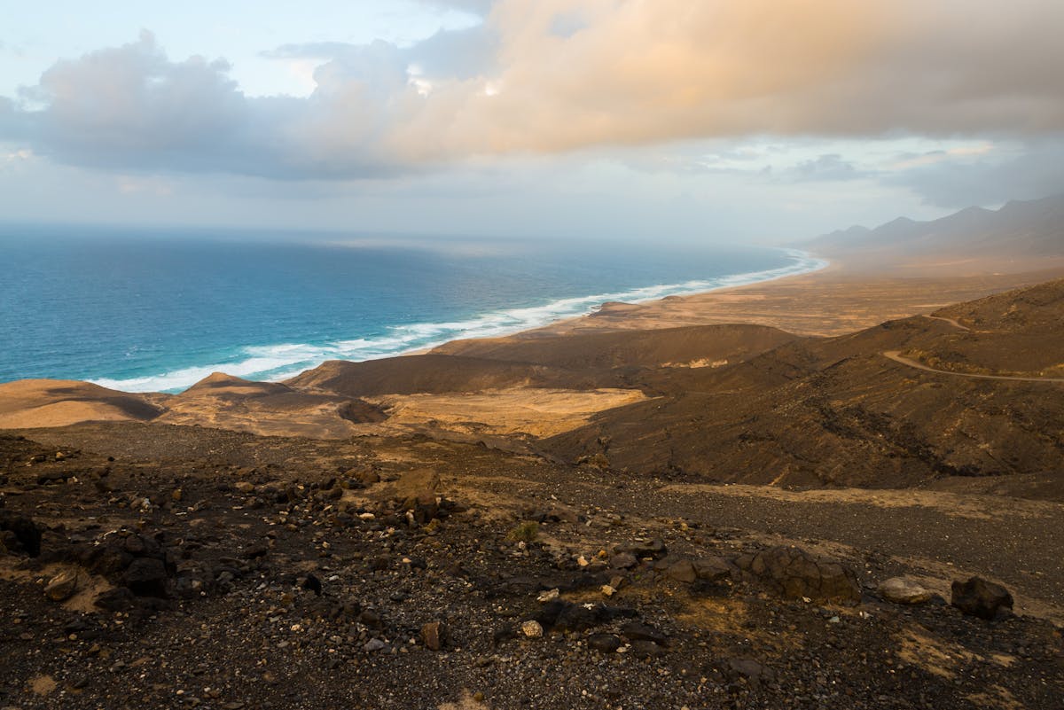Aerial shot of Fuerteventura's volcanic coastline with dramatic skies and rugged terrain