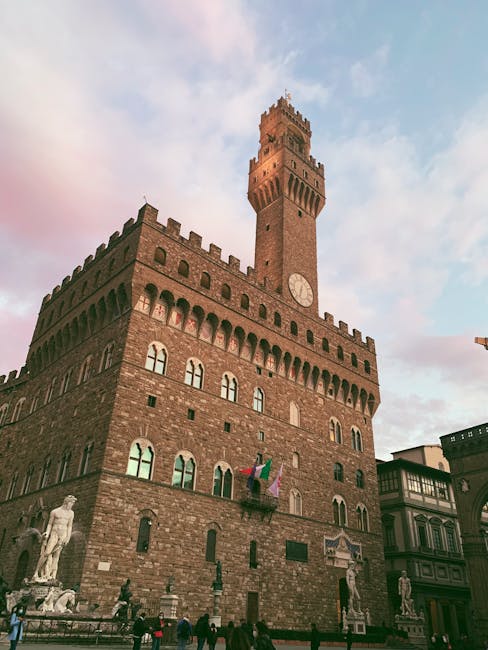 Palazzo Vecchio at sunset in Piazza della Signoria with statues