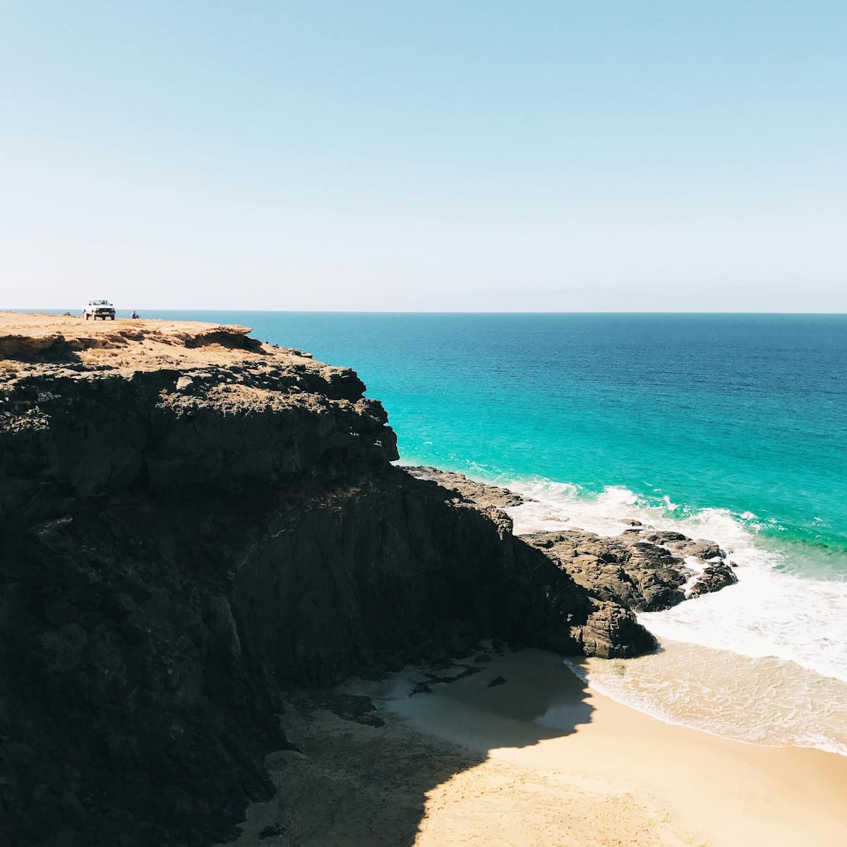 Turquoise ocean and rocky cliffs along the coast of Fuerteventura