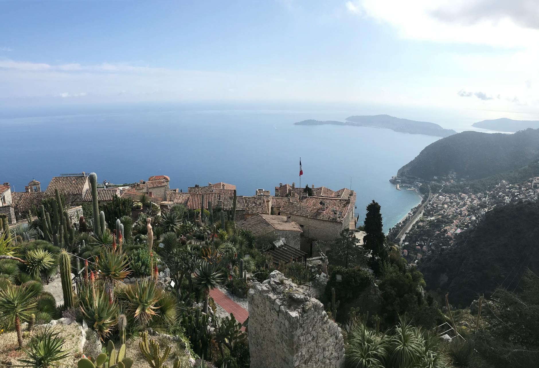 Medieval hilltop village on the French Riviera surrounded by green hills and blue sky