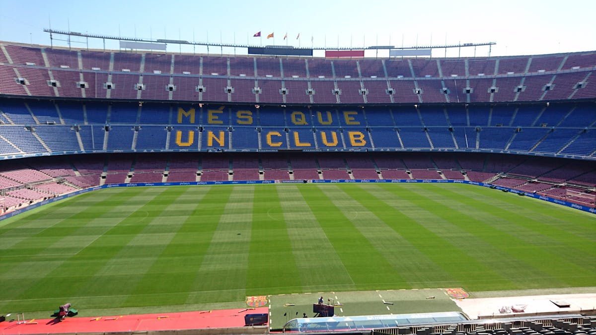 Panoramic view of Camp Nou stadium with Mes Que Un Club slogan visible on the seating