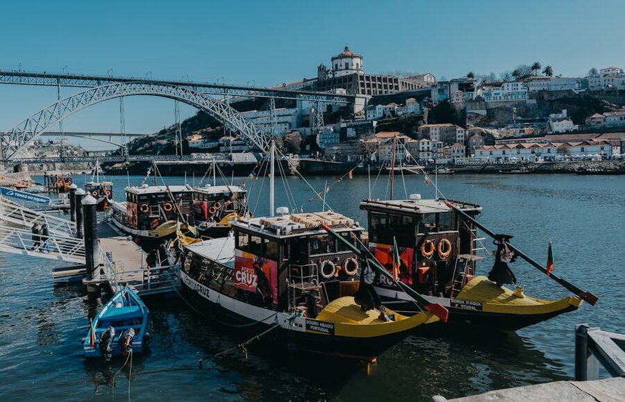 Boats on the Douro River with the iconic Dom Luis I Bridge in Porto