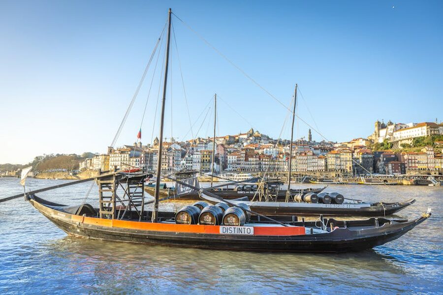 Traditional rabelo boats with port wine barrels on the Douro River Porto