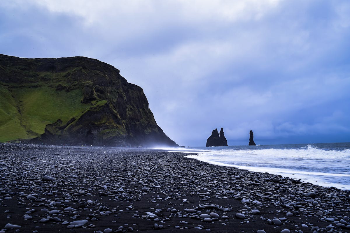 Reynisfjara black sand beach with basalt sea stacks in Iceland