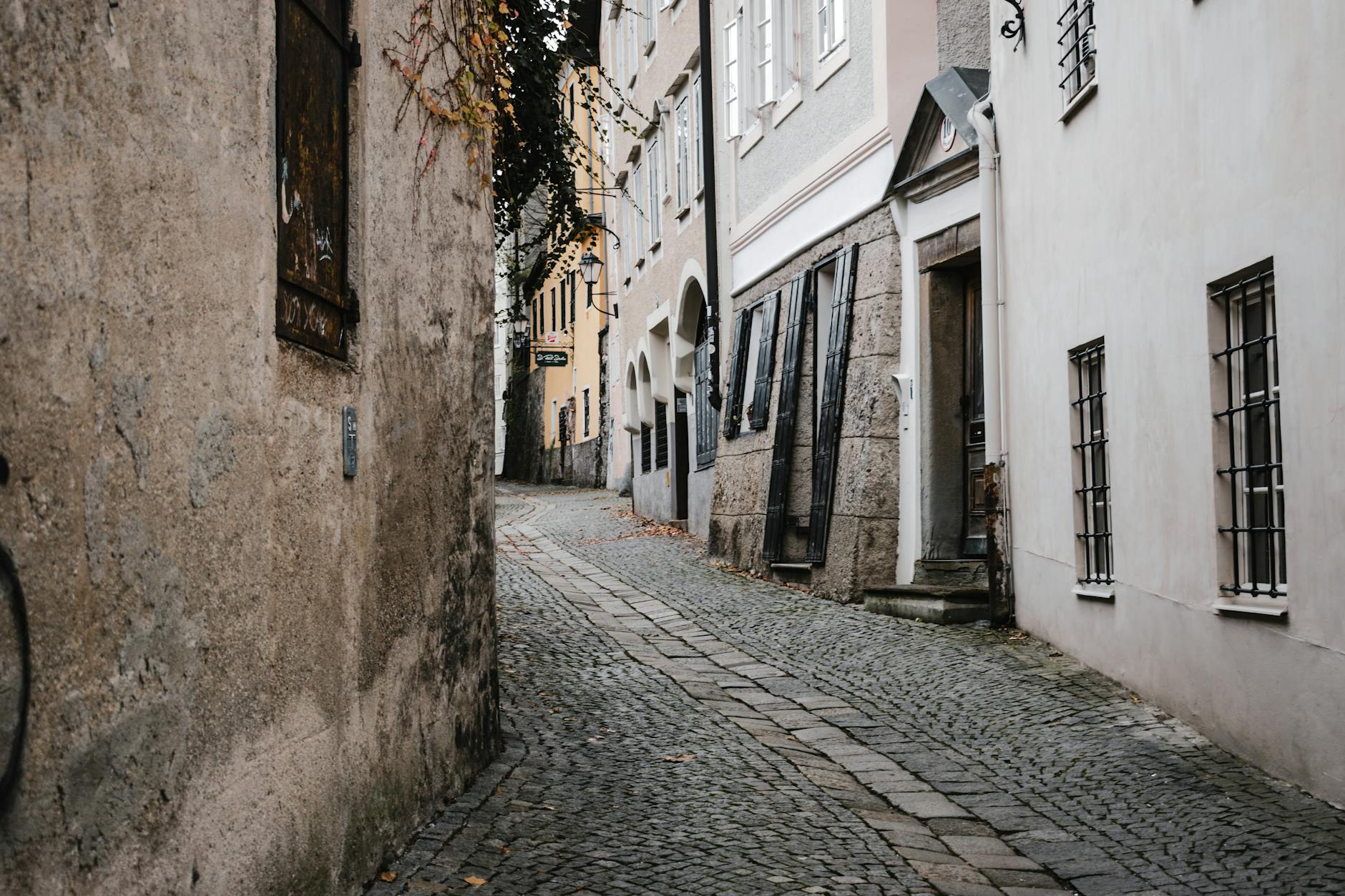 Historic cobblestone alley in Salzburg old town with traditional buildings