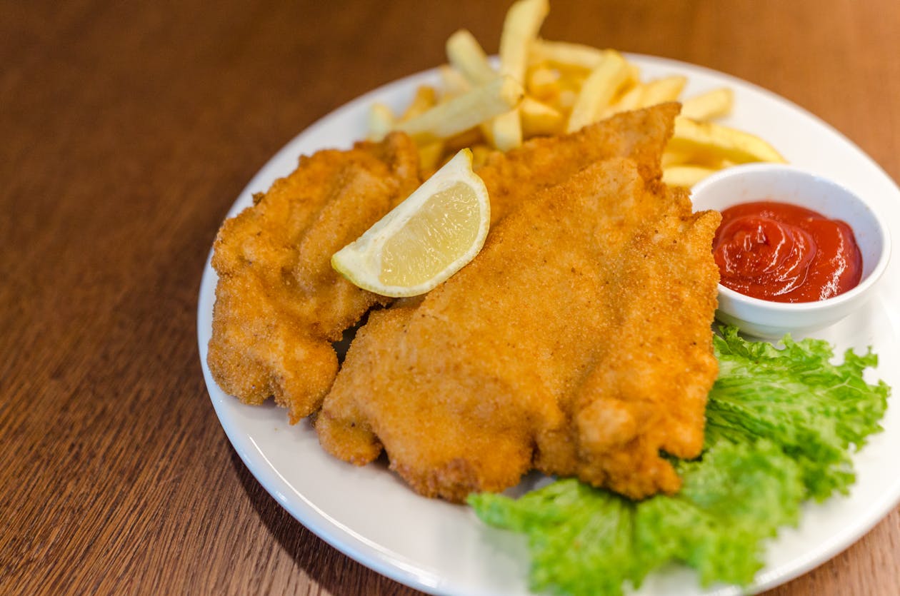 Golden wiener schnitzel served with fries and lemon