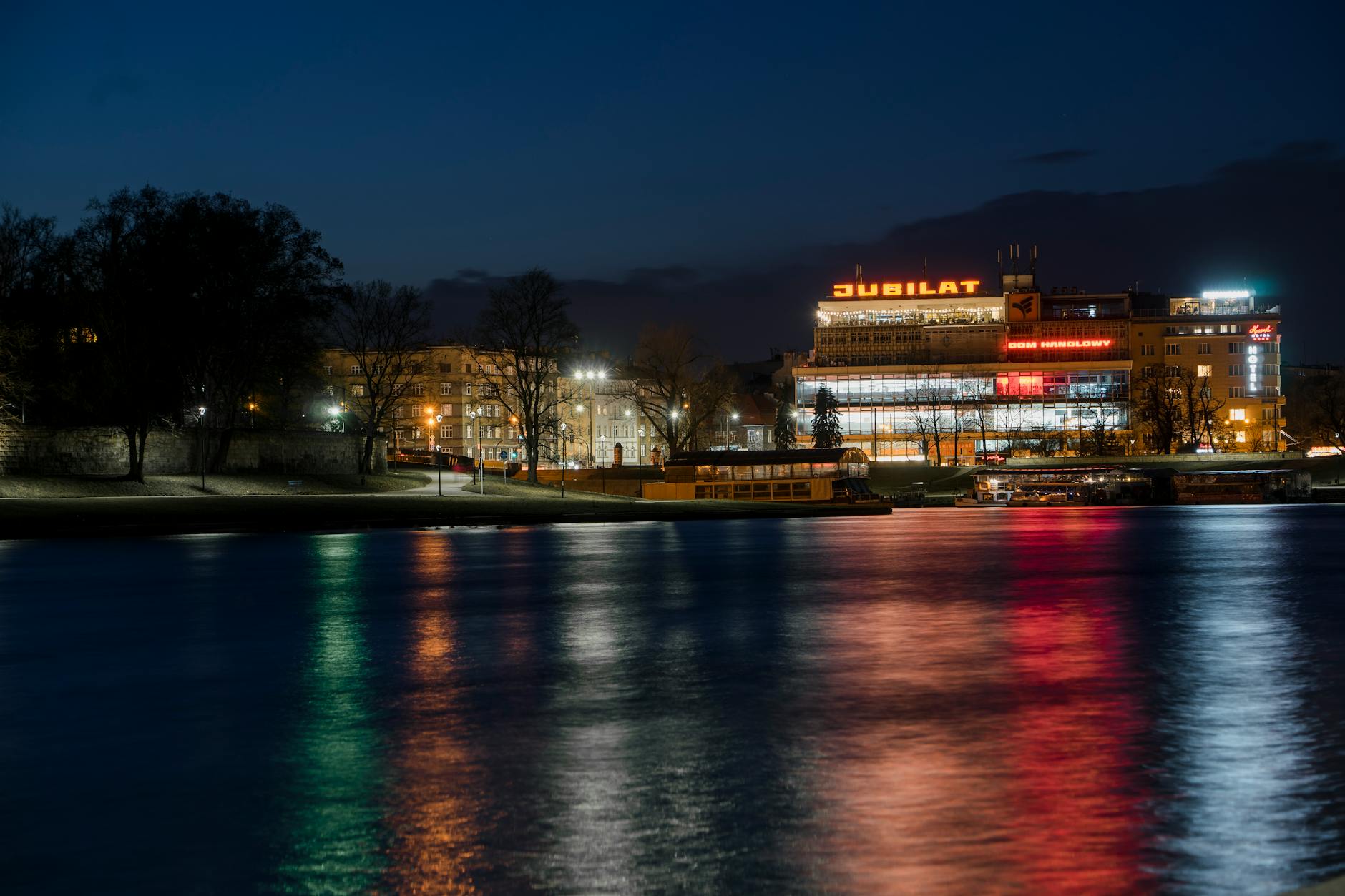 Krakow city lights reflecting on the surface of the Vistula River at night